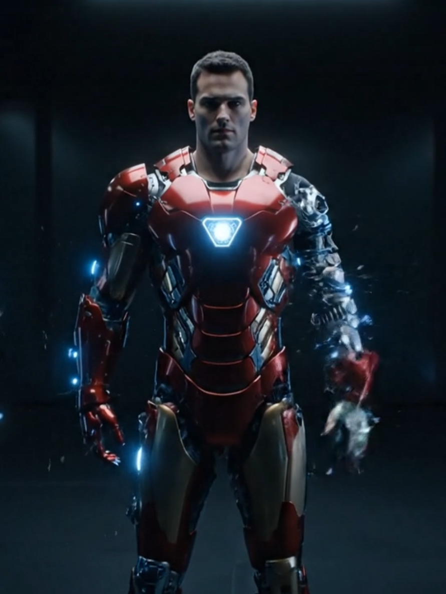 A cinematic transformation sequence. First frame: A realistic human man standing in the middle of a futuristic dark room, wearing casual clothes, looking determined. Gradually, shiny metallic red-and-gold Iron Man suit plates, gears, and armor parts attach to his body with cinematic motion, accompanied by metallic sound effects of steel clinking and locking in place. Sparks and glowing blue lights appear at the joints and arc reactor. Last frame: A fully completed Iron Man suit, futuristic and powerful, glowing eyes and chest arc reactor, standing strong in the same position, camera close-up for dramatic effect. Ultra realistic, cinematic lighting, 9:16, smooth transition. Audio: metallic clinking, robotic assembly sounds, futuristic mechanical hum. #ironmam #suit  #ai  #marvelprompt 
