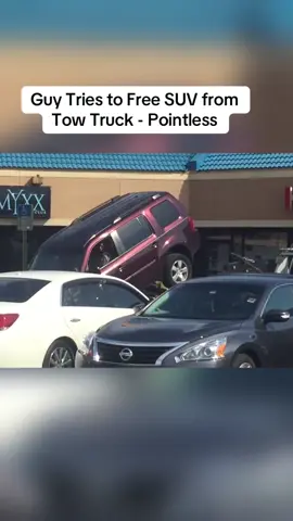 Guy Tries to Free SUV from Tow Truck - Pointless