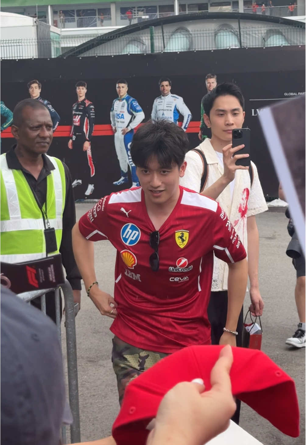 so nice of ZHOU GUANYU to sign under the rain 😭 #zhouguanyu #f1 #sggrandprix #paddock