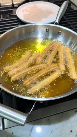 Traditional Churros Ingredients For the dough: 	•	1 cup water 	•	3 tablespoons vegetable oil (divided) 	•	2 tablespoons sugar 	•	Pinch of salt 	•	1 cup all-purpose flour For coating: 	•	½ cup sugar 	•	2 teaspoons cinnamon ⸻ Directions 	1.	Prepare the cinnamon sugar: In a bowl, combine the sugar and cinnamon. Set aside. 	2.	Make the dough: In a saucepan over medium heat, bring the water to a boil. Add 2 tablespoons of vegetable oil, sugar, and salt. Once it comes to a boil, lower the heat to medium-low and add the flour all at once. Stir until the mixture comes together into a smooth dough ball. (It’s okay if you see a few small bits of flour.) Cover the pan for about 1 minute, then remove from heat. 	3.	Rest the dough: Add the remaining 1 tablespoon of vegetable oil and transfer the dough onto your counter or a sheet of parchment paper. Be careful—it’ll be hot. You can fold the dough using parchment paper or wait until it’s cool enough to handle. Cover the dough and let it rest for 10 minutes. 	4.	Shape the churros: Cut parchment paper into long strips. Fill a piping bag fitted with a star tip (like Wilton 1M) or any large open tip with the dough. Pipe long strips of dough onto the parchment paper and cut the ends with scissors. Let the piped churros rest on the counter for 30 minutes. 	5.	Fry the churros: Heat oil in a deep pan to 350°F (175°C) or over medium heat. Carefully pick up each churro with the parchment paper and drop it into the oil (the paper will release easily). Fry for 4–5 minutes, turning occasionally, until golden brown. 	6.	Coat and serve: Remove the churros and place them on a paper towel to drain. While still warm, roll them in the cinnamon sugar mixture. Serve immediately and enjoy your crispy, golden, classic churros! #fyp #fypシ #Recipe #churros #EasyRecipe  