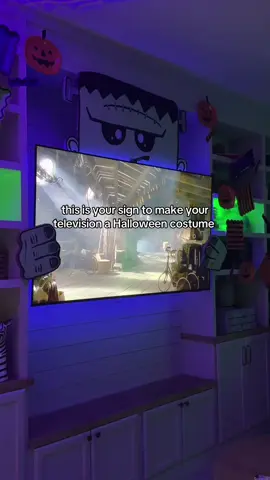 I dressed my television up like Frankenstein for Halloween! 🎃 all the lights are in my Bio!!  I cut Frankenstein out of a scrap piece of foam board I had - but cardboard would work perfectly too!! I gave him a quick paint job then mounted jim to the TV using tape. #DIY #diyhalloweencostume #diyhalloweendecor #diymama #halloweendecor  @HomeGoods @target @goveeofficial @SamsungUS  