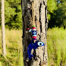 This wall-hanging evil eye features an evil eye in (nazar boncuk) in the shape of a dolphin made of handblown glass. It is adorned with a cube evil eye in the center of bright-colored wooden beads. This is truly what you have been looking for! Perfect for your home or office with stunning quality. **Wooden Colorful Beads will be random colors** Deflect negative thoughts and energy from all who enter with this modern and full-of-detail wall decor. Positive vibes only with this piece! This is the perfect gift. Ideal for birthdays, housewarming, new job, anniversaries, Christmas, Mother's Day, Valentine's Day, etc. Sizing Evil Eye -- 3.5 inches wide x 2.5 inches high Overall Length of Item -- 8 3/4 inches