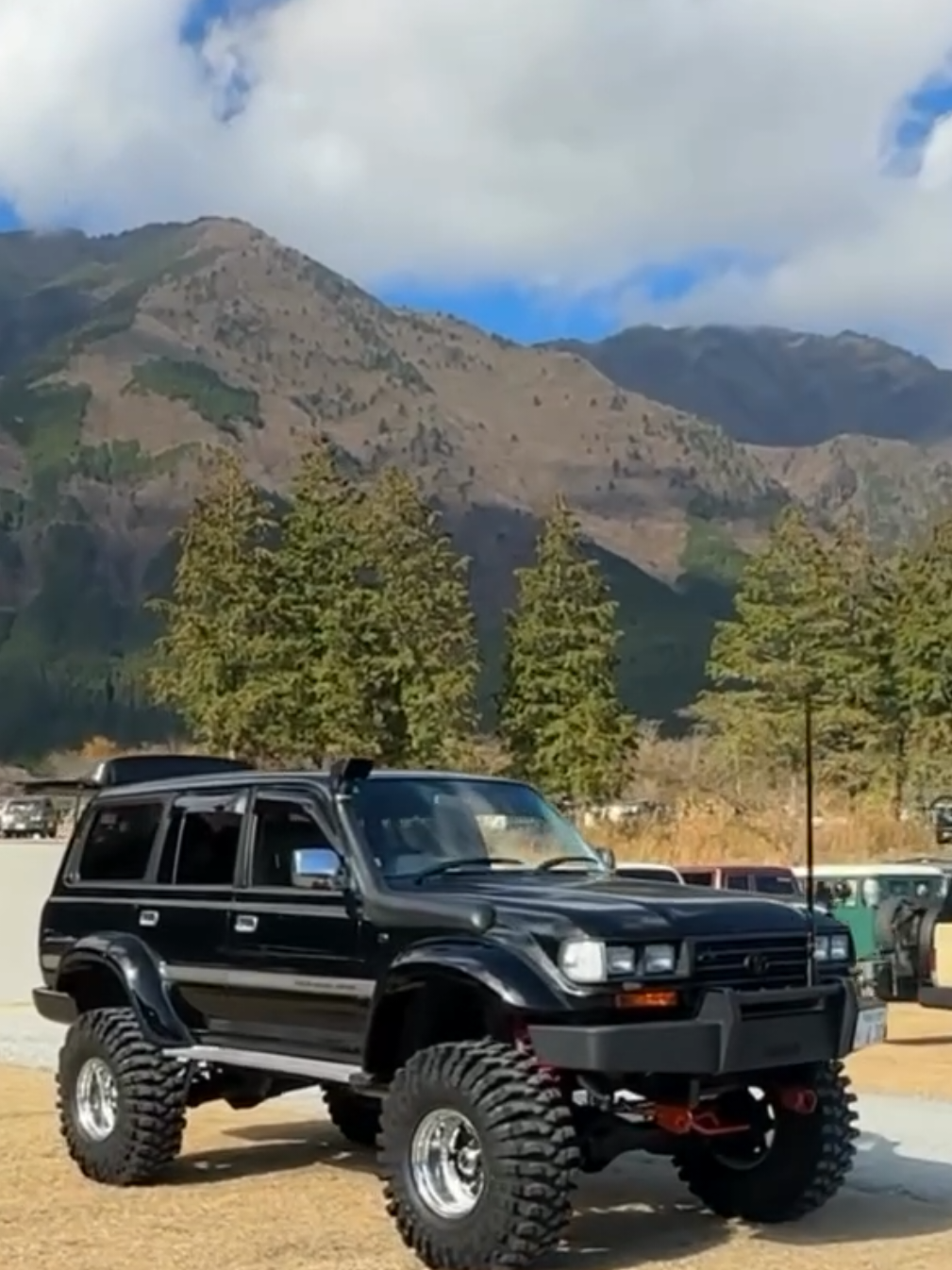 4 Beautiful fully modified Land Cruiser 80 series (also known as FJ80 or LC80) off-road vehicles parked side-by-side. All vehicles are black and feature extensive modifications for off-road use, including significant suspension lifts and large, aggressive all-terrain tires. #vxlimited24valve  #landcrusiervx80  #vxcruiser  #80serieslandcruiser  #toyotalandcruiser 