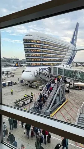A giant shadow stretches across the runway as the multi-storey skyliner prepares for boarding. Passengers step through glass walkways into different levels of the aircraft — one entrance for the panoramic lounge deck, another for the luxury sleeper cabins, and a main level buzzing with travellers ready for adventure. Inside, spiral staircases connect the decks while huge wraparound windows show the airport lights glowing in the evening. From the top observation level you can literally watch luggage being loaded below and planes taxiing past. Imagine boarding a plane where the journey already feels like a destination. Multiple floors, restaurants, quiet lounges, and endless views as this giant prepares to lift into the night sky. Would you explore every level before takeoff? ✈️🌙 #airport #travel #aviation #future #skyliner 