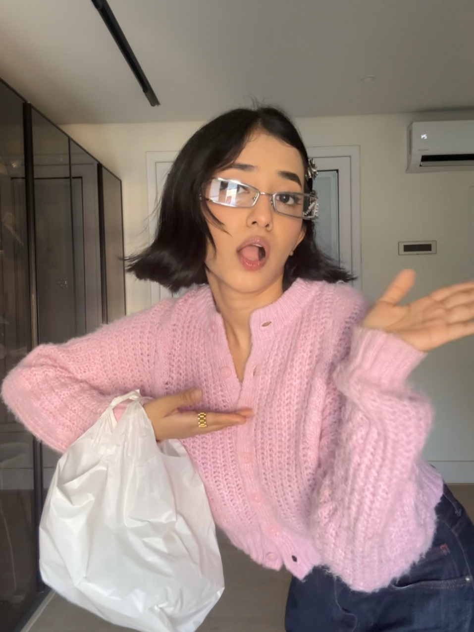 it has been clarified, she is actually carrying a regular plastic bag