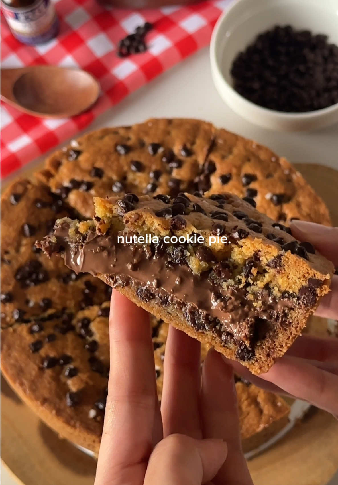 nutella stuffed cookie pie🍫🍪 Ingredients: 200g (1 cup) unsalted butter, softened  150g (3/4 cup) brown sugar 50g (1/4 cup) granulated sugar 1 egg + 1 egg yolk 1 tsp vanilla 320g (2 2/3 cups) all purpose flour 1 tsp baking soda 1 tsp salt 120g (3/4 cup) chocolate chips/chunks, plus more for toppings 250-300g nutella, for filling Flakey sea salt, for topping Instructions: 1. In a large bowl, cream together the butter, brown sugar, and white sugar until well combined. 2. Add the egg, egg yolk, and vanilla, then mix until smooth. 3. Add the flour, salt, and baking soda. Gently fold until just combined. 4. Fold in the chocolate chips until evenly distributed. Do not overmix. (If the dough is too soft, chill it for about 30 minutes.) 5. Prepare an 8-inch pan. Press about 70% of the dough evenly into the bottom. 6. Spread the Nutella evenly over the dough. Flatten the remaining dough and place it on top to cover, sealing the edges. 7. Sprinkle extra chocolate chips on top. Bake in a preheated 170°C (340°F) oven for 35–40 minutes, or until the edges are set and the center is slightly soft and golden. 8. Sprinkle with flaky sea salt and let it cool before removing from the pan. 9. Slice and enjoy while warm! #baking #cookiepie #nutella #nutellacookiepie #chocolate 