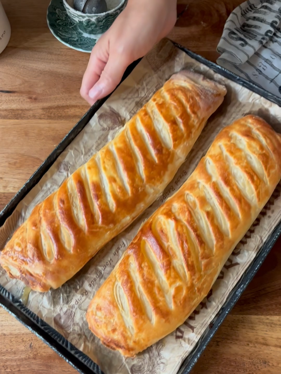 Katmer Turkish Sivas katmer: 1.5 cups of warm milk (You can use half water) 1 teaspoon of yogurt 1 teaspoon salt About 5 cups flour (add carefully) 10 gr baking powder For between: 150 g melted butter 1 teaspoon of oil For flling: Feta Cheese, mozarella etc. For top: 1 egg yolk 1 tbsp milk Take the liquids and salt into the mixing bowl and mix. Prepare a soft dough that does not stick to the hand by adding flour and baking powder, let it rest by covering for 20 minutes. While the dough is resting, melt the butter and add the oil. Divide the rested dough into 8 equal balls and roll it out as much as you can by sprinkling a little flour on it. Apply butter with brush and fold it all over, take it asid. Roll it out again another ball and grease it all over and place the other folded dough into it. Apply oil to the folded areas and set aside, prepare the other balls in the same way, cover them with a freezer bag and let them rest in the refrigerator for at least 60 minutes, then take them to the counter, open them with a rolling pin and add the cheese, fold them from the sides, prepare them in the same way and put them on the baking tray. Whisk 1 egg yolk and 1 tablespoon of milk on them thoroughly and apply, score with a knife. Bake in a preheated 200 degrees . If you wish, prepare the katmer from the evening and put it in the refrigerator, add the cheese and cook it the next day. Sivas katmeri : 1,5 su bardağı ılık süt (Yarısını su kullanabilirsiniz)  1 çay bardağı yoğurt  1 tatlı kaşığı tuz 5 su bardağı un (dikkatli ekleyin) 1 pkt (10 gr ) kabartma tozu Aralara sürmek için :  150 gr tereyağı 1 çay bardağı sıvı yağı  İsteğe bağlı iç olarak :  Beyaz peynir, kaşar vb  İsterseniz içsiz de yapabilirsiniz .  Üzerine:  1 yumurta sarısı 1 yk süt Sıvıları ve tuzu yoğurma kabına alın çırpın. Un ve kabartma tozunu ekleyerek yumuşak ele yapışmayan bir hamur hazırlayın üzeri kapalı 20 dakika dinlendirelim Hamur dinlenirken tereyağını eritin sıvıyağını da içine aktarın .  Dinlenen hamur 8 esit bezeye bölün ve tezgaha un serperek açabildigimiz kadar açın . Heryerini yağlayıp katlayın bir kenara alın , tekrar bir beze açın ve heryerini yağlayıp diğer katladığımız hamuru içine yerlestirin. Katladığnız yerlere de yağ sürüp bir kenara alın diğer bezeleri de aynı şekilde hazırlayıp üzeri buzdolabı poşeti ile kapatıp en az 60 dak buzdolabında dinlendirin daha sonra tezgaha alıp merdane ile açıp peyniri ekleyin yanlardan katlayın hepsini aynı şekilde hazirlayip fırın tepsisine alın. üzerlerine 1 yumurta sarısı ve 1yemek kaşığı sütü iyice çırpıp sürün bıçak ile çizikler atın önceden Isıtılmış 200 derece alt üst ayarda pişmeye bırakalım nar gibi kızarınca fırından alın.  Dilerseniz katmerleri aksamdan hazırlayıp buzdolabına kaldırın ertesi gün peynirini ekleyip pişirin