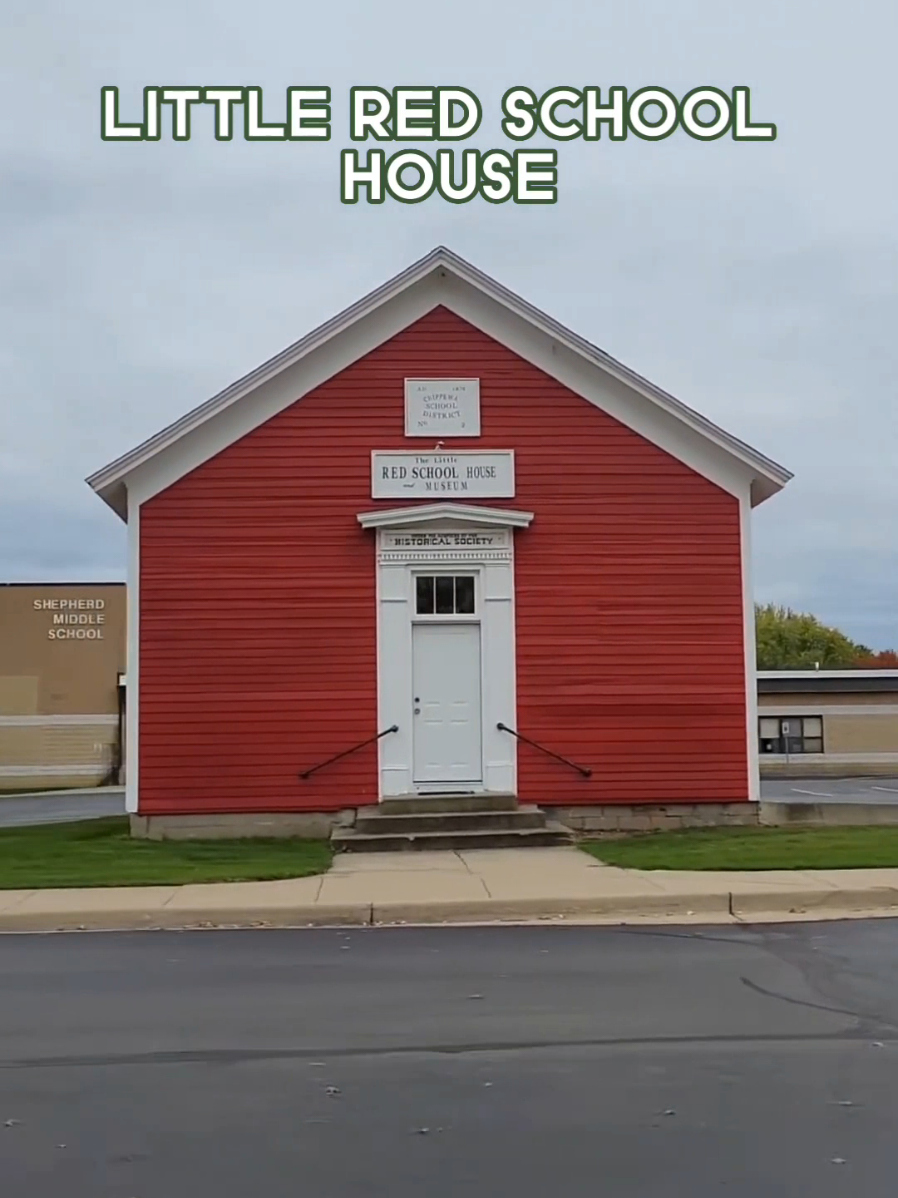 Little Red School House & Museum is a red wooden building with a white sign that reads 