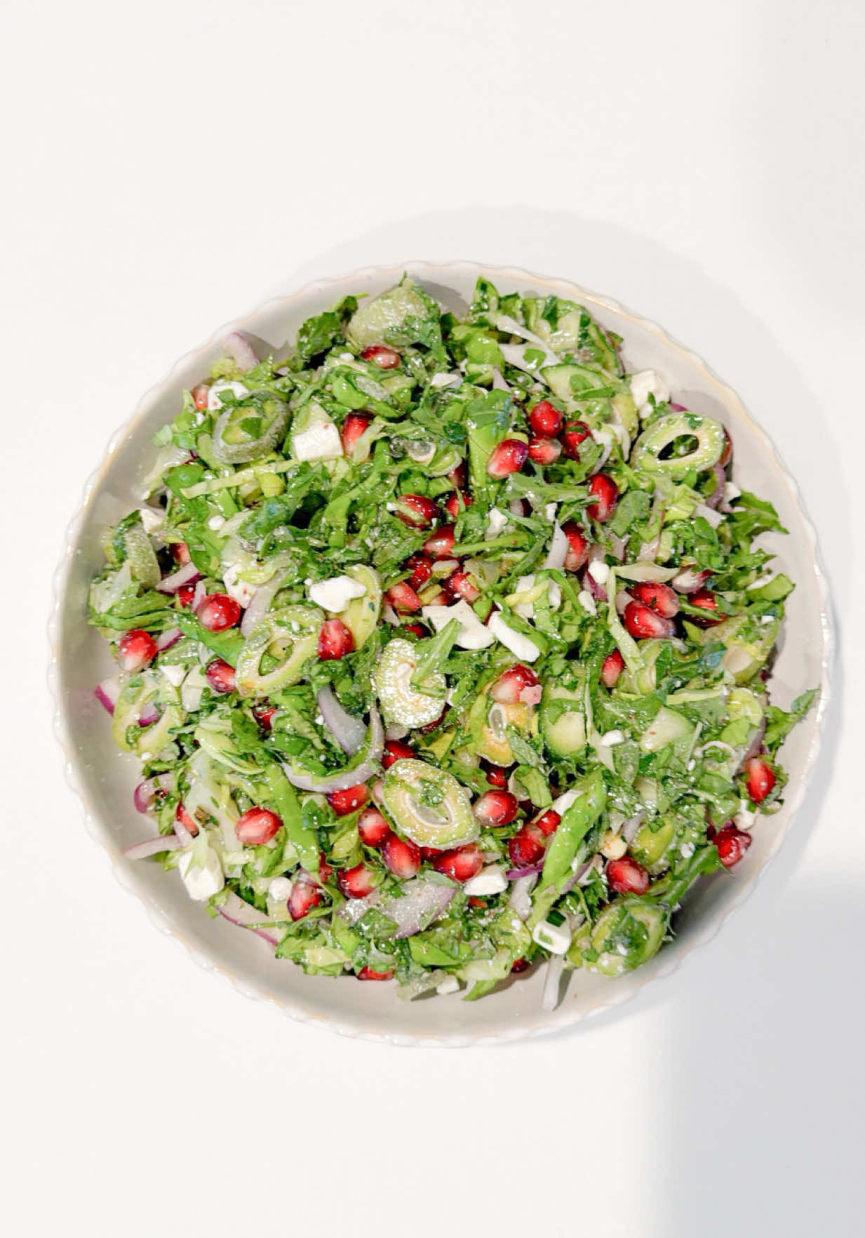 Upgraded my “oily grass salad”. Green Almond & Herb Salad ! Take advantage while they’re in season 🥰  Ingredients Salad •	1 cup green almonds, thinly sliced •	1 large head romaine lettuce, finely chopped •	2 Persian cucumbers, diced •	1 small bunch parsley, finely chopped •	1 small bunch mint, finely chopped •	1 small bunch oregano, finely chopped •	1 small handful arugula, roughly chopped •	½ small red onion, very thinly sliced •	1 pomegranate, seeds removed •	½ cup feta cheese, crumbled Dressing •	Juice of 1 - 1 1/2 lemons (to taste) •	¼ cup extra virgin olive oil •	1–2 tsp sumac •	Salt, to taste Method 1.	Prep the base Finely chop the romaine and transfer to a large mixing bowl. Add cucumbers, herbs (parsley, mint, oregano), and arugula. 2.	Build texture Add the thinly sliced green almonds and red onion. Toss lightly to distribute. 3.	Add brightness & richness Fold in the pomegranate seeds and crumbled feta. 4.	Make the dressing In a small bowl, whisk together lemon juice, olive oil, salt, and sumac until balanced—bright, slightly tangy, and well seasoned. 5.	Dress & serve immediately Pour dressing over the salad and toss gently until evenly coated. Serve immediately as a side along with some protein.  #salad #food #asmr #cooking #Foodie 