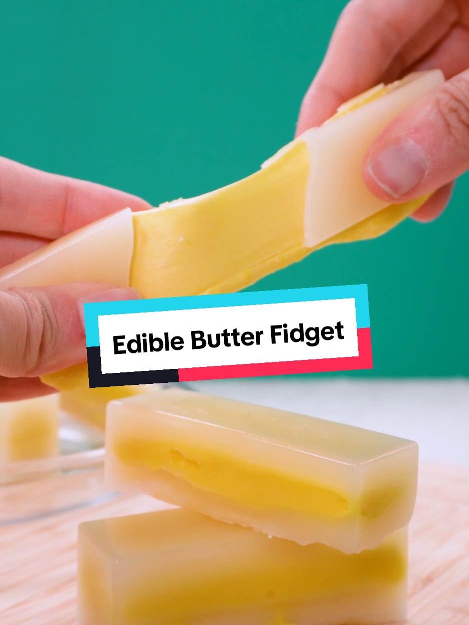 Making an EDIBLE FIDGET TOY using BUTTER?! ✨Recipe: Ingredients: • Food-grade beeswax • 3 tbsp butter • 5½ cups mini marshmallows Directions: 1. Melt the beeswax in a saucepan until fully liquid. Pour a small amount into rectangular molds and rotate to coat the bottom and sides. Repeat as needed to build up several layers and create a sturdy shell. 2. In a separate saucepan over low heat, melt the butter and marshmallows together, stirring until smooth and fully combined. 3. Spoon or pour the marshmallow mixture into the wax shells, leaving a little room at the top. 4. Cover the filling with another layer of melted beeswax to seal the candy closed. 5. Allow the candies to cool and fully harden before removing them from the molds. 6. Squeeze, mold, and chew your way through these sweet, fidget-inspired treats! 🍬🧈