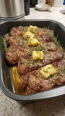 Recipe Name Garlic Butter Rosemary Steak Ingredients 1. Ribeye or sirloin steaks – 4 large 2. Butter – 8 tbsp 3. Garlic, minced – 6 cloves 4. Fresh rosemary sprigs – 4 5. Olive oil – 2 tbsp 6. Salt – 2 tsp 7. Black pepper – 1 tsp 8. Fresh parsley, chopped – 1 tbsp Recipe 1. Remove the steaks from the refrigerator 30 minutes before cooking. 2. Pat the steaks dry with paper towels. 3. Season both sides generously with salt and black pepper. 4. Heat olive oil in a large skillet over high heat. 5. Sear the steaks for 3–4 minutes on each side. 6. Reduce the heat to medium. 7. Add butter, garlic, and rosemary to the pan. 8. Spoon the melted garlic butter continuously over the steaks. 9. Cook until the desired level of doneness is reached. 10. Transfer the steaks to a baking dish. 11. Pour the remaining garlic butter sauce over the top. 12. Let the steaks rest for 5–10 minutes. 13. Garnish with chopped parsley. 14. Serve hot with your favorite side dishes. Follow our account for more delicious recipes every day!