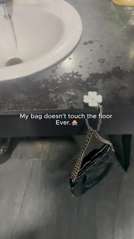 Stop putting your nice bags on questionable public restroom floors! 🤢 This pocket-sized hook is an absolute lifesaver. It folds up perfectly to fit in your purse and keeps your bag clean, safe, and off the ground. 🙅‍♀️✨ #baghack #pursehook #musthaves #tiktokmademebuyit #cleangirl 