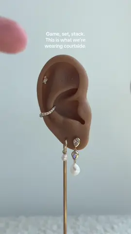 The only thing more iconic than a winning serve? A perfectly curated ear stack of course 🎾✨  #astridandmiyu #jewellery #earstack #piercing #tennis 