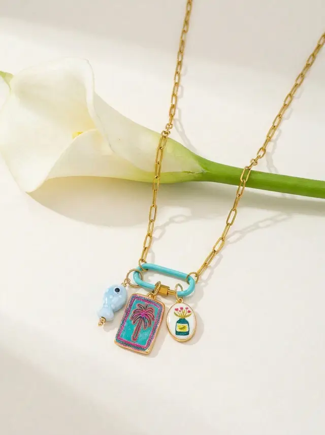 One joyful statement, refined for modern luxury. Our 18K gold plated paperclip chain anchors a turquoise enamel carabiner clasp and three interchangeable charms: palm tree rectangle, light blue dotted fish, and a petite oval vase motif. Designed for effortless swaps and secure wear, this single SKU brings polished boho energy to sunlit days and chic nights—always centered, clean, and unmistakably you. #CharmNecklace #EnamelJewelry #18KGoldPlated #CarabinerClasp #PalmTree #Turquoise #BohoLuxury #VacationStyle #SummerJewelry #MinimalEditorial #EcommerceCampaign