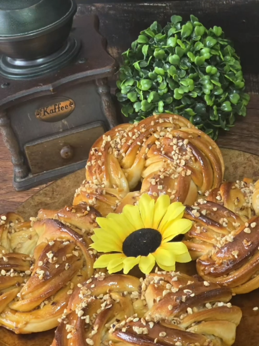 Ti mit szóltok a sós karamellás desszertekhez? Ha ezt a sós karamellás kalácsot szívesen kipróbálnátok, a receptet itt találjátok. 😀❤️ Recept👇 A tészta hozzávalói • BL55 finomliszt: 400 g  • Friss élesztő: 18 g, vagy szárított élesztő: 5g  • Só: 6 g  • Cukor: 45 g  • Vaj: 55 g  • Tojás: 1 db + 1 tojássárgája  • Vanília aroma: ízlés szerint  • Tej: 160 ml  A sós karamell töltelék hozzávalói • Cukor: 120 g  • Habtejszín: 120 g  • Vaj: 40 g  • Só: 1 csipet  • Keményítő: 6 g + kevés víz  A cukorszirup hozzávalói • Cukor: 33 g  • Víz: 25 ml  • Só: 1 csipet  Szükséges még továbbá enyhén durvább szemű só, valamint apróra vágott, pirított mogyoró a töltelékbe – a mogyoró továbbá a felület dekorálásához is. Az elkészítés menete 1. Karamell töltelék A cukrot karamellizáljuk, több részletben hozzáadjuk a tejszínt, simára keverjük. Levesszük, belekeverjük a vajat, majd keményítővel röviden besűrítjük és sózzuk. Langyosra hűtjük.  2. Tészta készítése Az élesztőt langyos tejben kevés cukorral felfuttatjuk. A liszttel és a többi alapanyaggal (vaj kivételével) dagasztani kezdjük, majd a vaj hozzáadásával sima tésztát készítünk.  3. Tésztaérés Letakarva kb. 45 percig pihentetjük.  4. Formázás A tésztát kinyújtjuk, megkenjük karamellel, megszórjuk sóval és magokkal. Feltekerjük, hosszában elvágjuk, összefonjuk, majd koszorú formában sütőlemezre helyezzük (4 db).  5. Kelesztés Letakarva 30–40 percig kelesztjük.  6. Sütés 200°C-ra előmelegített sütőbe tesszük, majd 180°C-on kb. 20–22 perc alatt készre sütjük.  7. Szirupozás Cukorból és vízből szirupot főzünk, a forró babkákat átkenjük, majd megszórjuk pirított mogyoróval.  8. Hűtés Rácson hagyjuk kihűlni, szükség esetén A recept minden pontos részlete megtekinthető a részletes YouTube recept videómban 