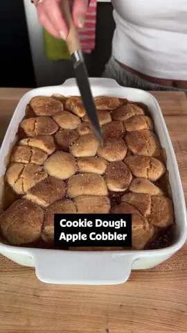 This easy apple cookie cobbler is the easiest version of fruit cobbler ever made. 🍎🧡 Tap the link in our bio for full recipe details or keep reading! ⤵️ Ingredients: 2 cans pie filling, such as apple, blueberry or cherry 1 (16.3 ounce) tube refrigerated sugar cookie dough 3 tablespoons white sugar 1 1/2 teaspoons ground cinnamon Directions: Preheat the oven to 350 degrees F (180 degrees C) and lightly grease the sides of a 9x13-inch baking dish. Pour pie filling into the bottom of the dish. Break apart cookie dough into 10 to 12 smaller pieces and flatten them very slightly. Place them randomly over the top of the pie filling, covering as much of the top as possible, leaving some parts of pie filling uncovered. Stir together sugar and cinnamon in a small bowl and sprinkle mixture evenly over the top of cookie dough. Bake in the preheated oven until lightly browned and bubbly, for 30 to 35 minutes. Serve with vanilla ice cream if desired. 🎥: Natalie @guacmylife #cookiedough #apples #cobbler #baking