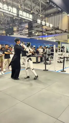 UBTECH is putting humanoid coordination on display in Beijing. At the 2026 World Robot Conference, this UBTECH humanoid mirrors a human dance partner through turns, arm movements and full-body steps, turning balance and locomotion into a live interaction demo. A simple dance exposes a lot: timing, foot placement, whole-body control and the ability to keep moving around a person in a crowded real-world environment. Via X: @techniahqrobot #UBTECH #HumanoidRobot #HumanoidRobotics #PhysicalAI #EmbodiedAI 