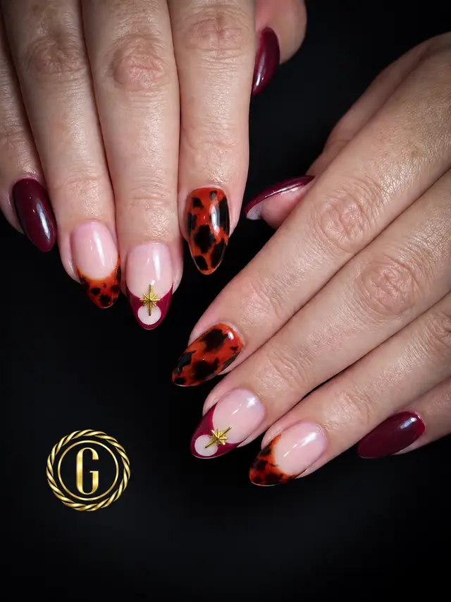 Rich, warm, and sophisticated! 🐆🍷 Elegant burgundy paired with tortoiseshell full nails, matching tortoiseshell French tips, and delicate gold starburst accents on an oval shape. Book your next set with us today! 🫶 Genova Nail Memorial 📍Address: 14622 Memorial Dr, Houston, TX 77079 ☎️Phone: (281) 372-6899 #luxurynailsalon #genovanailspa #memorialnails #tortoiseshellnails #burgundynails