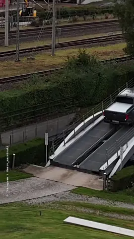 🚙⚙️ Ungewöhnliche Szene auf einer beweglichen Rampe: Ein schwarzer Pick-up fährt nach vorne, während sich der obere Teil der Konstruktion absenkt. ⚠️ Als der Fahrer etwas schneller vorrollt, bewegt sich die Rampe deutlich schneller nach unten. ↩️ Offenbar aus Sorge vor einem zu harten Aufprall setzt er kurz zurück. 🚘 Anschließend versucht er es erneut und fährt vorsichtiger nach vorne. ✅ Dadurch senkt sich die Rampe deutlich kontrollierter ab.