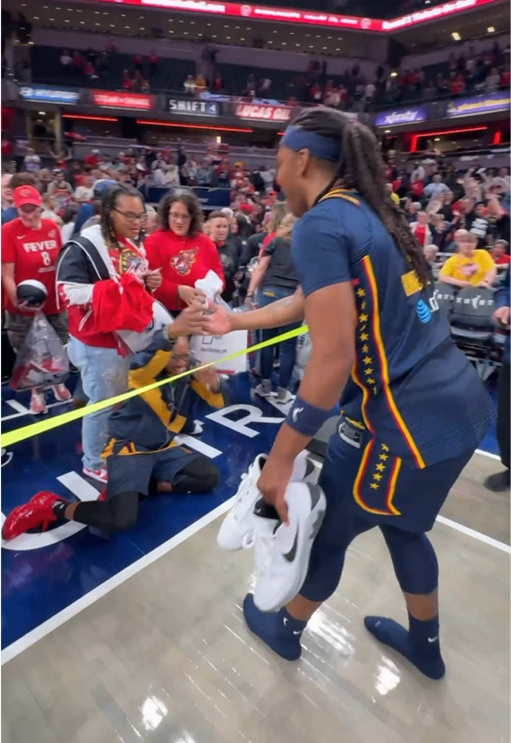 this fan was on the floor after receiving Myisha Hines-Allen's game-worn sneakers 😆