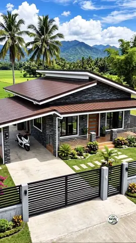 🇵🇭 MODERN TROPICAL BUNGALOW | CONTEMPORARY LIVING IN THE COUNTRYSIDE 🤎 A sophisticated single-storey residence designed to blend modern tropical architecture with the peaceful beauty of the Philippine countryside. Featuring layered brown metal roofing, elegant dark stone-inspired walls, warm wood accents, and beautifully landscaped outdoor spaces, this home creates a refined yet welcoming rural retreat. 📐 Estimated Floor Area: 75–90 SQM 🛏️ Estimated Bedrooms: 2 Bedrooms 🛁 Estimated Bathrooms: 1 Bathroom 🎨 ARCHITECTURAL PALETTE • Rich brown long-span metal roofing with layered roof design • Dark charcoal-gray stacked-stone exterior walls • Clean white roof fascia and architectural trims • Warm natural wood-finish main entrance door • Black aluminum-framed windows with tinted glass • Sleek stainless-steel porch railings with geometric accents • Warm wood-look flooring at the covered front veranda • Modern gray concrete perimeter wall and driveway • Contemporary black horizontal-slat steel gate 🌿 LANDSCAPE & OUTDOOR LIVING • Spacious covered carport integrated into the house • Manicured tropical front lawn with stepping-stone pathways • Carefully arranged ornamental plants and colorful foliage • Bougainvillea and tropical greenery surrounding the property • Tall coconut palms creating a natural tropical atmosphere • Expansive green rice fields overlooking the home • Scenic mountain views forming a dramatic countryside backdrop • Peaceful rural setting perfect for relaxed provincial living 📌 AI-generated architectural concept for inspiration only. Actual dimensions, structural design, materials, and construction specifications may vary. #NGN