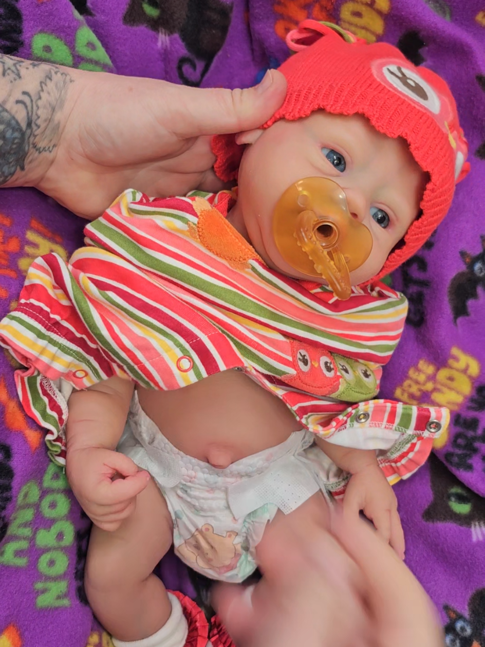 Changing reborn silicone doll into Halloween outfit. 