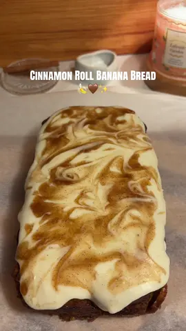 Cinnamon Roll Banana Bread 🍌🤎 Banana Bread Batter • 3 ripe bananas (300–360 g) • 5 tablespoons melted butter (70 g) • 1 egg (50 g) • 1/4 cup Greek yogurt or sour cream (60 g) • 1/2 cup brown sugar (100 g) • 1/4 cup granulated sugar (50 g) • 1 teaspoon baking soda (5 g) • 1 teaspoon cinnamon (3 g) • Dash of salt (1–2 g) • 1 1/4 cups all-purpose flour (156 g) • 1 teaspoon vanilla bean paste Cinnamon Middle Layer • 2 1/2 tablespoons all-purpose flour (19–20 g) • 1/3 cup brown sugar (67 g) • 2 teaspoons ground cinnamon (5–6 g) Cinnamon Swirl Topping • 1/4 cup light brown sugar, packed (50 g) • 2 tablespoons unsalted butter (28 g) • 1 tablespoon ground cinnamon (8 g) • 1 1/2 tablespoons heavy cream (22.5 ml) • 1/2 teaspoon vanilla extract (2.5 ml) Small Buttercream Frosting Ingredients: * 1 tbsp butter, softened * 1 cup powdered sugar * ½ tsp vanilla extract * 1–2 tbsp heavy whipping cream Instructions Preheat the oven to 375°F (190°C). Grease a loaf pan and line the bottom with parchment paper. Mash the bananas in a medium bowl until smooth. Add the melted butter and Greek yogurt (or sour cream) and whisk until combined. Mix in the brown sugar, granulated sugar, egg, and vanilla bean paste until smooth. Add the baking soda, cinnamon, salt, and flour, then gently fold everything together just until no dry streaks remain. Do not overmix. In a separate bowl, combine the flour, brown sugar, and cinnamon for the cinnamon middle layer until crumbly. Pour half of the banana bread batter into the prepared loaf pan and sprinkle the cinnamon mixture evenly over the batter. Spread the remaining batter on top. To make the cinnamon swirl topping, melt the butter in a small saucepan over low heat. Stir in the brown sugar and cinnamon until combined. Mix in the heavy cream and vanilla extract until smooth. Allow the mixture to cool slightly, then drizzle it over the banana bread batter. Use a toothpick or knife to gently swirl it into the top layer. Bake for 45–60 minutes, or until a toothpick inserted into the center comes out clean or with a few moist crumbs. If the top begins browning too quickly, loosely cover it with foil. Let the bread cool in the pan before slicing. Enjoy your cinnamon roll banana bread! 🍌🤎#cinnamonroll #bananabread #baking #recipes #bananabreadrecipe 