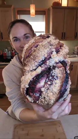 Blueberry streusel twisted bread. Known as a babka! Recipe makes one large loaf! Blueberry compote: 1 cup fresh blueberries  1 TBS sugar  1 TBS water Cook on medium heat until berries are soft. Blend, return to pot and cook on medium heat. Stir in cornstarch slurry (3 tsp cornstarch, 3 tsp water, mixed) to thicken. Once thickened pour into a container, cover with plastic wrap and refrigerate. Dough: 4 cups all purpose flour  3 eggs 1 cup warm water 3 tsp yeast 1/4 cup sugar 2 tsp salt 3 TBS neutral oil  Mix all ingredients on stand mixer. Once dough comes together, knead on speed 2 for 7 minutes. Place dough in lightly oiled bowl, cover and let rise til doubled in size (about 1 1/2 hours). Streusel topping: 1/4 cup flour 1/3 cup sugar 1 1/2 TBS cold butter  Mix with fingertips until coarse. Keep in the refrigerator until ready to use. Follow instructions on shaping in the video. Place in parchment or silicone lined 9x5 bread loaf pan. Cover and let rise 45 minutes. Preheat oven to 375°. Brush the top with milk, sprinkle with streusel, bake at 375° for 35-40 minutes until internal temp reaches 190° #bread #FoodTok #homemade #Recipe #delicious 