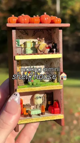 cozy little shelf home 🏠🧡 i’ve had this idea for ages but i wasn’t sure if it would look as cute as i was picturing… what do we think?? 🥹🧸 thank you em for my little Glostie!!👻 @moodishroom matching Ghost Bestie nails🤍💅 @glamnetic  #mini #miniature #artprocess #minihouse #spooky 