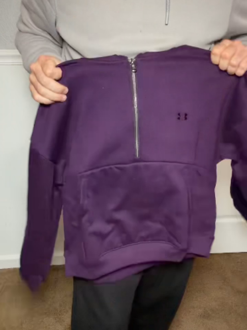 The Christmas gift she will pull on every day, filmed on the real one. The Under Armour women's half zip hoodie in Purple Echo, a soft fleece pullover with a stand collar and a chrome half zip with a ring pull, a kangaroo pocket, ribbed cuffs and hem, and a clean plain back. Small tonal embroidered logo on the chest, no drawstrings. More colors on the listing. #UnderArmour #HalfZip #ChristmasGiftIdeas #TikTokshopBlackFriday #CozyStyle
